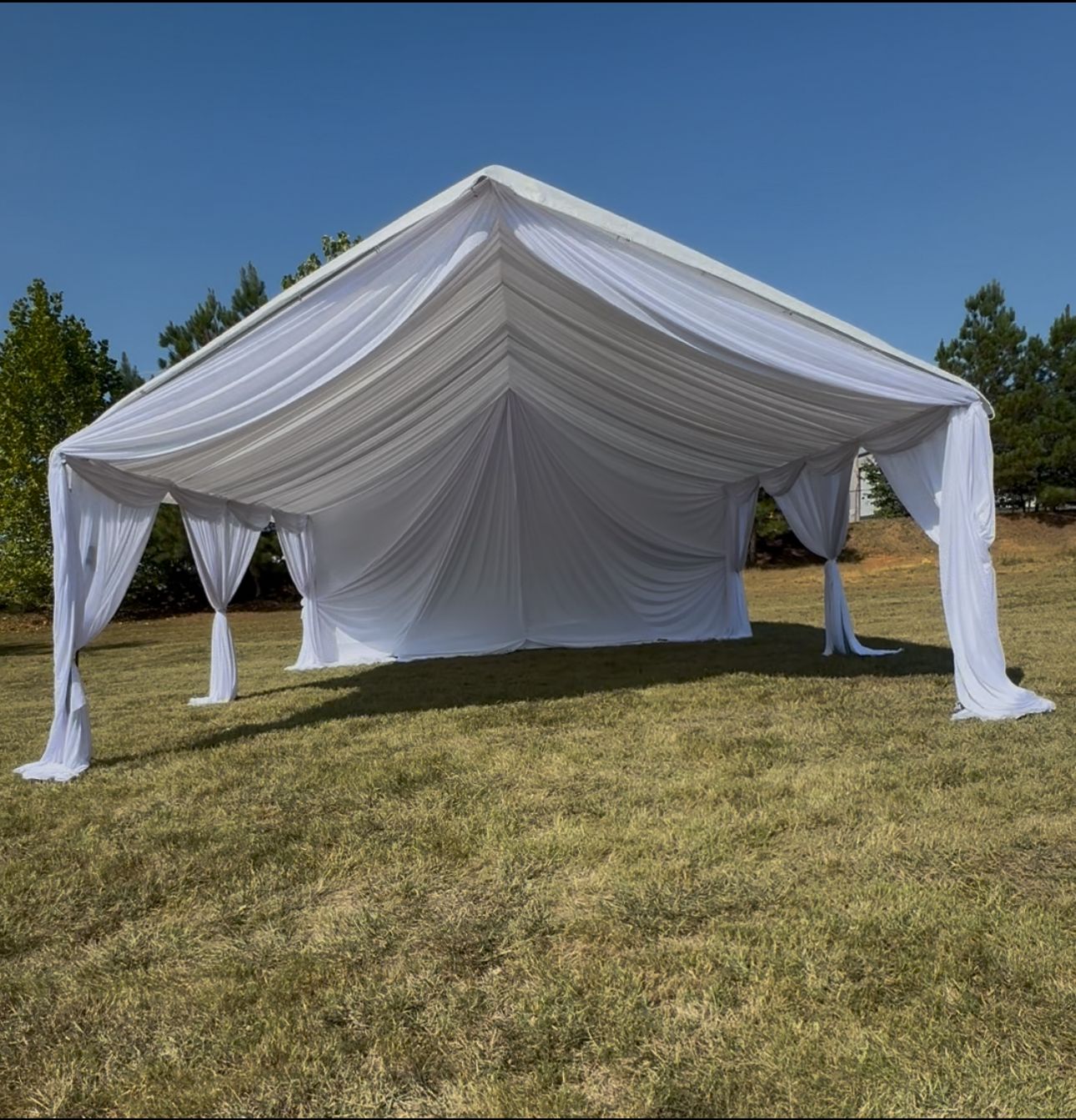 Draped event space with warm party styling by Guerreros Party Rentals